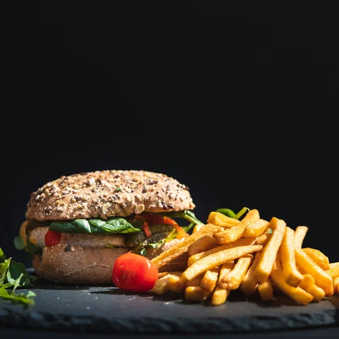 Burger and fries on a dark background